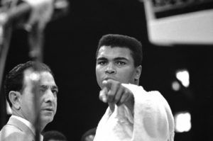 Heavyweight champion Muhammad Ali is momentarily displeased after weigh-in ceremony, May 25, 1965 in Lewiston, Maine, arena. Challenger Sonny Liston will be the object of Ali?s more potent attentions in 15-round title bout tonight. Liston weighed 215 ¼ and Clay 206. (AP Photo)